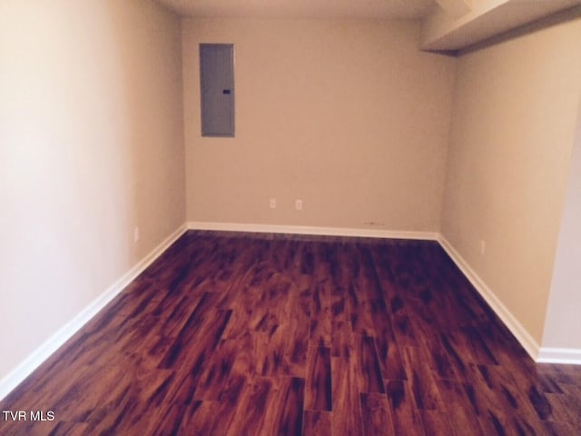 basement with electric panel and dark hardwood / wood-style floors