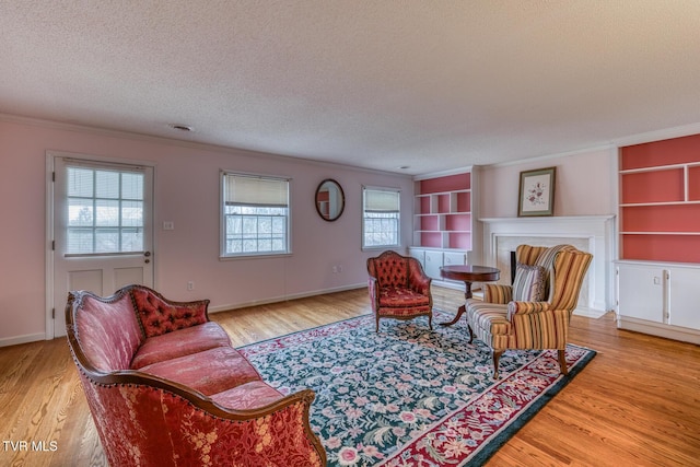 305 Overbrook Dr, Bristol, TN 37620 - living area with a textured ceiling, a fireplace, crown molding, and light wood-style floors