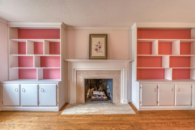 305 Overbrook Dr, Bristol, TN 37620 - unfurnished living room featuring a textured ceiling, light wood-style floors, crown molding, and a fireplace