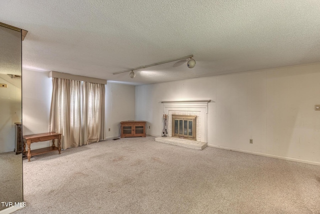 305 Overbrook Dr, Bristol, TN 37620 - unfurnished living room with a fireplace, rail lighting, carpet, and a textured ceiling