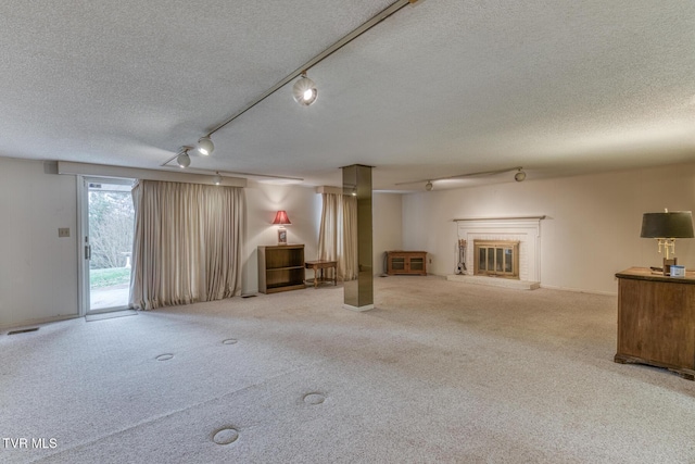 305 Overbrook Dr, Bristol, TN 37620 - unfurnished living room with rail lighting, a brick fireplace, a textured ceiling, and light carpet
