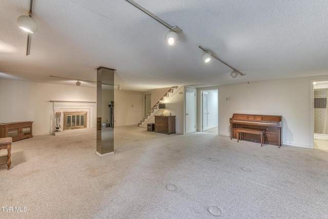 305 Overbrook Dr, Bristol, TN 37620 - finished basement with a textured ceiling, stairs, a glass covered fireplace, and light carpet