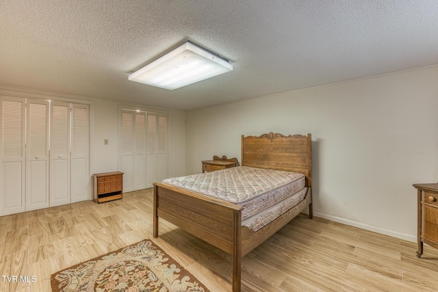 305 Overbrook Dr, Bristol, TN 37620 - bedroom with a textured ceiling, two closets, baseboards, and light wood-type flooring