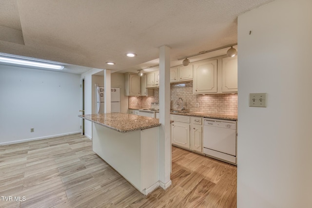 305 Overbrook Dr, Bristol, TN 37620 - kitchen with light wood-style flooring, a textured ceiling, white appliances, tasteful backsplash, and light stone countertops