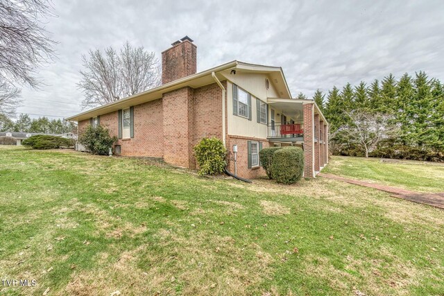 305 Overbrook Dr, Bristol, TN 37620 - view of side of home featuring a balcony, brick siding, a yard, and a chimney