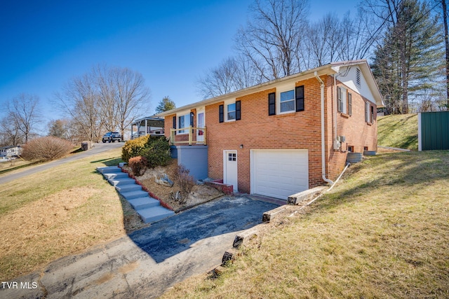 view of front of home featuring brick siding, a front lawn, an attached garage, and aphalt driveway