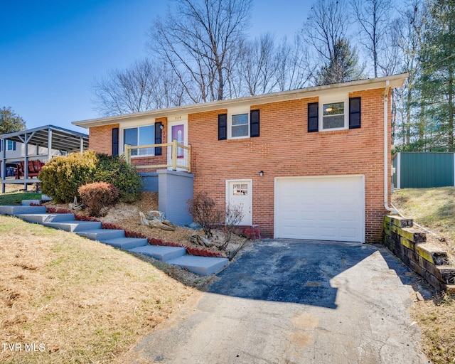 view of front of home with aphalt driveway, brick siding, and an attached garage