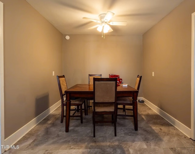 dining area with ceiling fan and baseboards