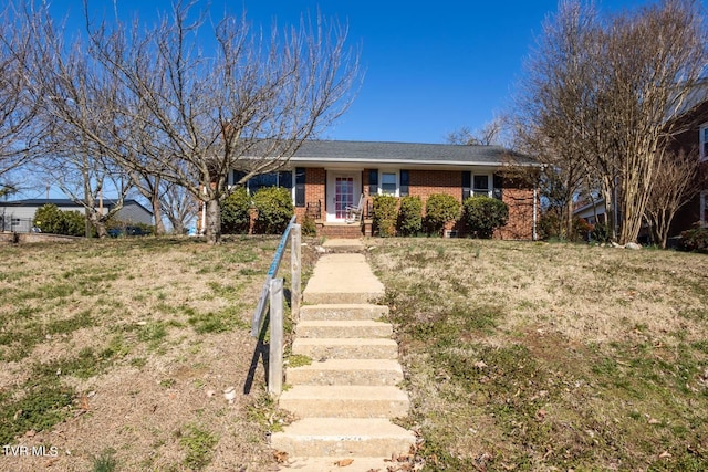 ranch-style home featuring a front lawn and brick siding