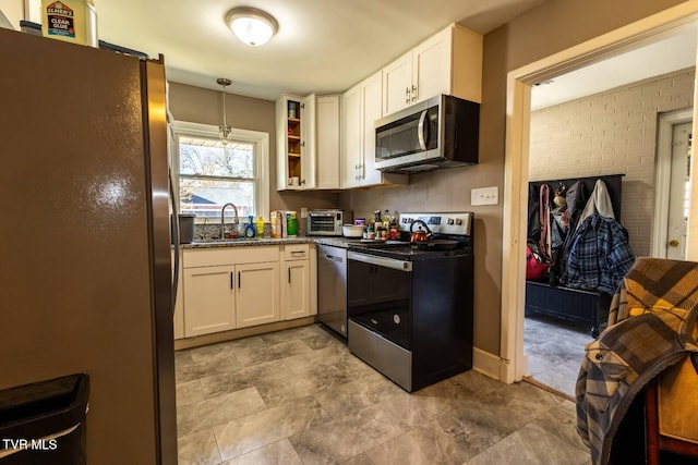 kitchen with hanging light fixtures, open shelves, appliances with stainless steel finishes, and white cabinets