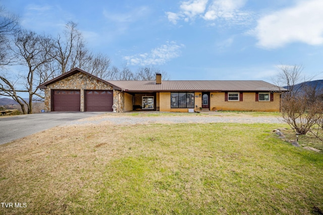 ranch-style home with a garage and a front lawn