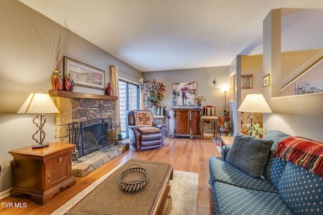 living room with light wood-type flooring and a fireplace