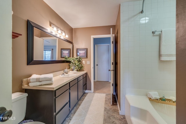 full bath featuring toilet, a bathing tub, vanity, and baseboards