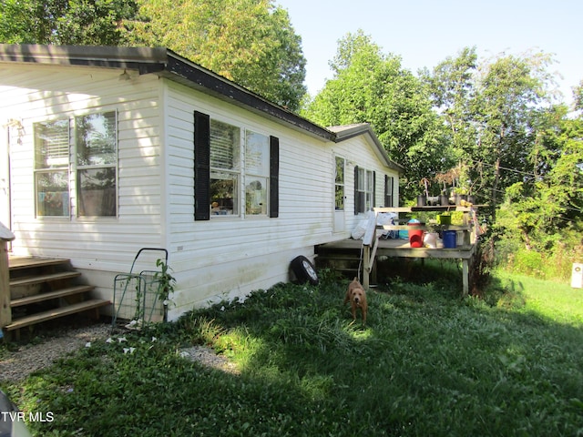 view of side of home with a wooden deck