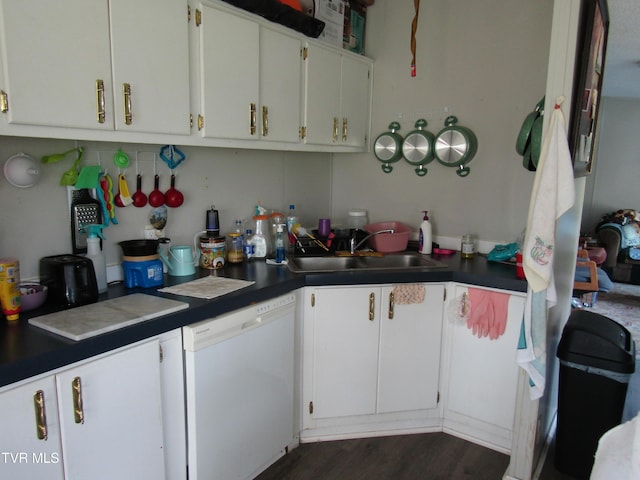 kitchen with dark wood finished floors, white cabinetry, dishwasher, and a sink