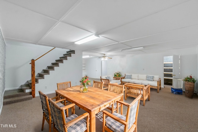 dining space with ceiling fan and carpet flooring