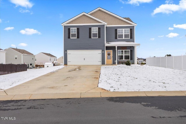 view of front of house featuring an attached garage, fence, and concrete driveway