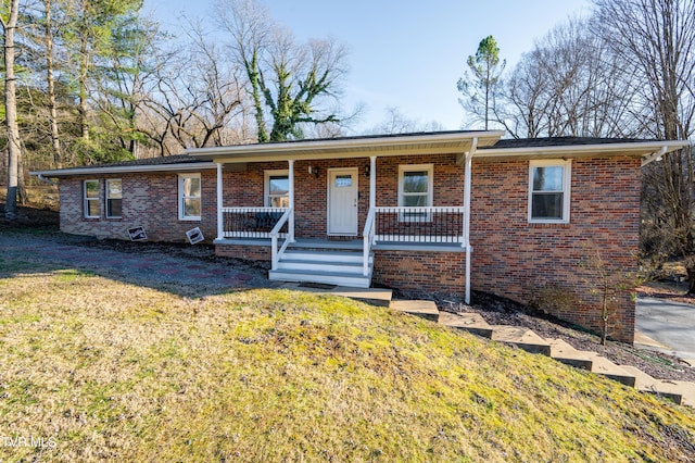 ranch-style home with a porch, brick siding, and a front lawn