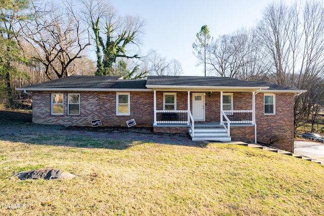 ranch-style home featuring covered porch, a front lawn, and brick siding