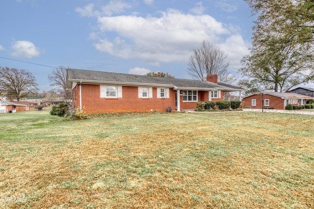 ranch-style home with a front lawn