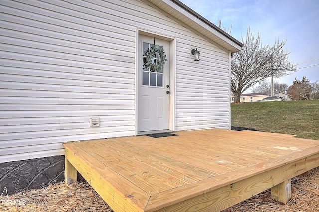 view of exterior entry with a wooden deck