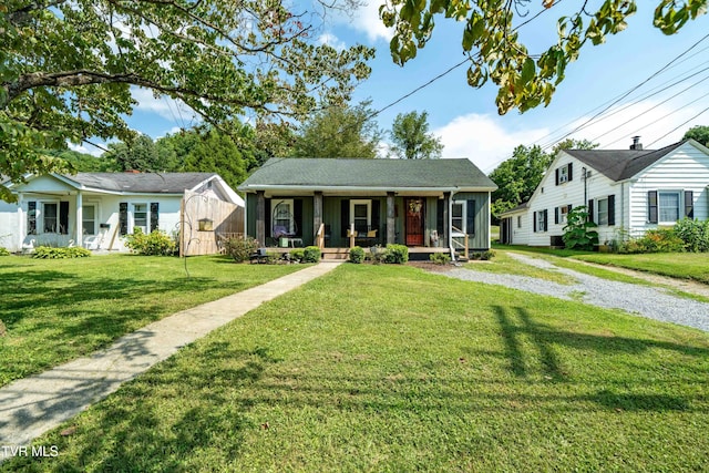 bungalow-style house featuring covered porch, driveway, and a front lawn