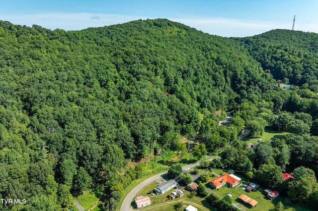 birds eye view of property featuring a view of trees