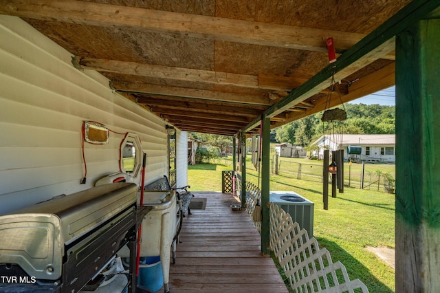 deck with a lawn and central AC