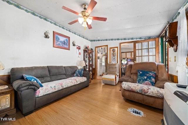 living area with ceiling fan and light wood finished floors