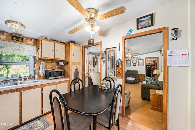 dining room with a ceiling fan and light wood-style floors