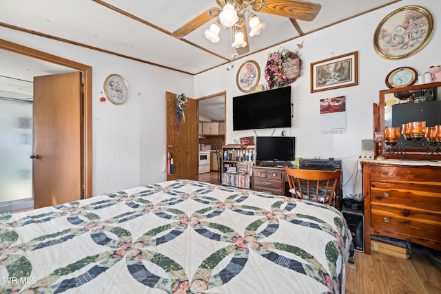 bedroom with crown molding and wood finished floors