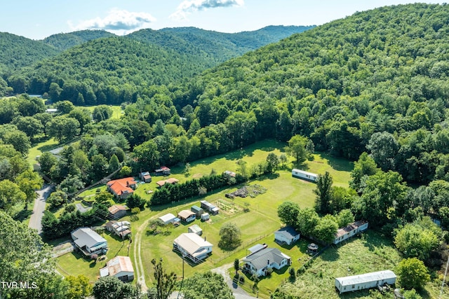 birds eye view of property with a wooded view