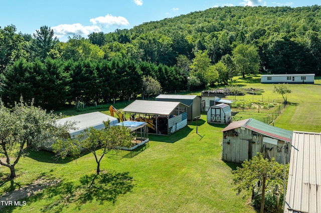 drone / aerial view with a wooded view