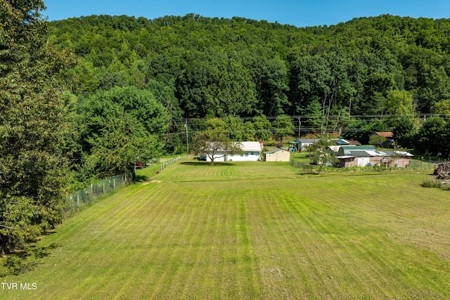 drone / aerial view featuring a wooded view and a rural view