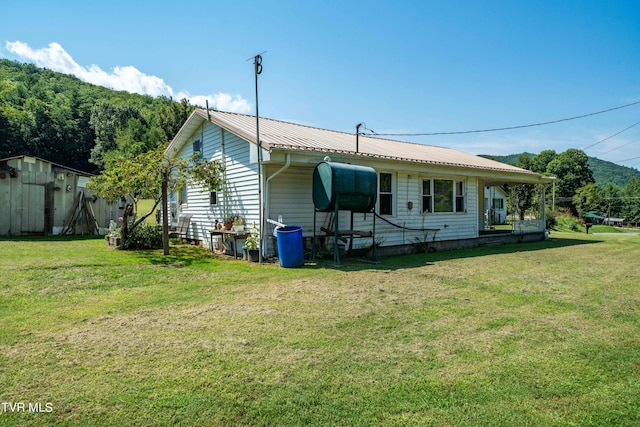 exterior space with metal roof and a front yard