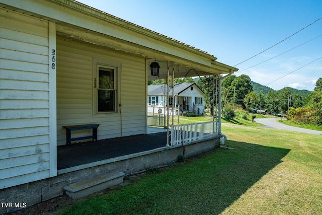 exterior space featuring a porch and a yard