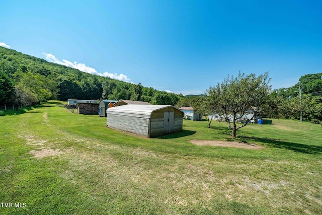 view of yard with a wooded view