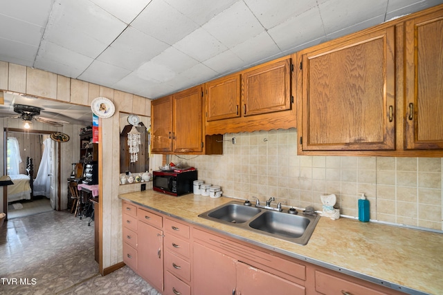 kitchen featuring a sink, light countertops, and brown cabinets