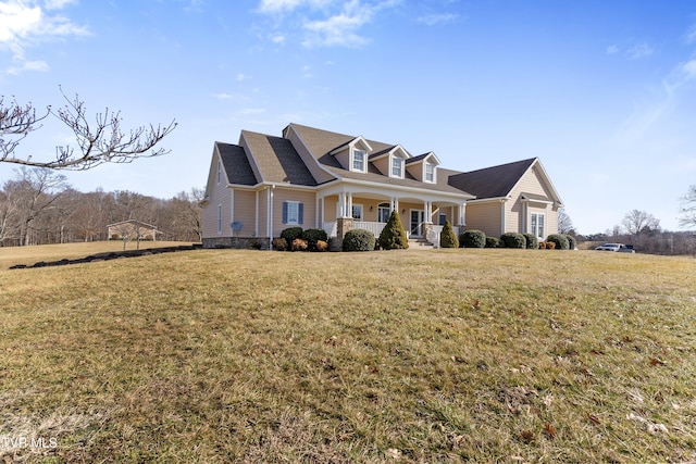 cape cod-style house featuring covered porch and a front yard