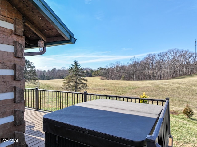 deck with a lawn and a rural view