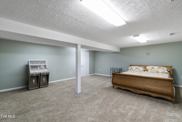 carpeted bedroom featuring a textured ceiling and baseboards