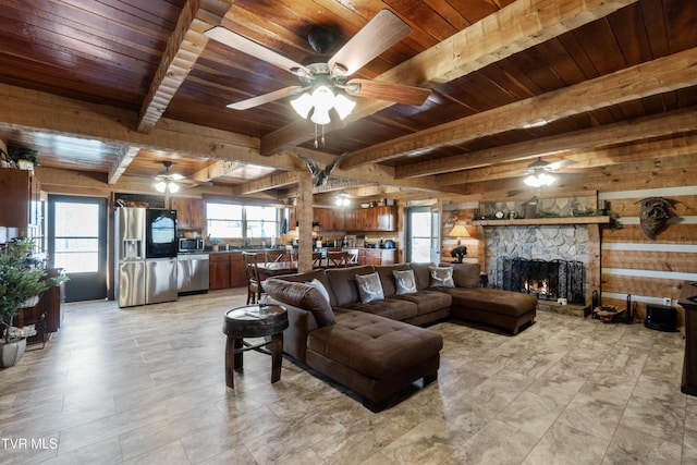 living room with a ceiling fan, wood ceiling, and beam ceiling