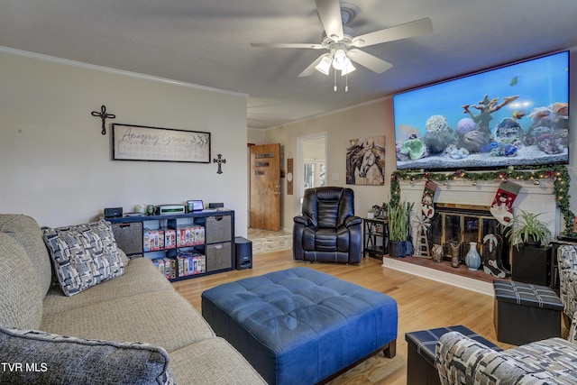 living room with a glass covered fireplace, crown molding, and wood finished floors