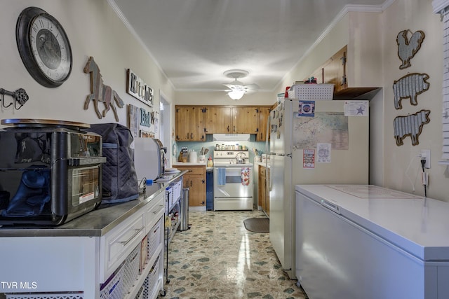 kitchen featuring brown cabinetry, stainless steel electric range oven, freestanding refrigerator, light countertops, and crown molding