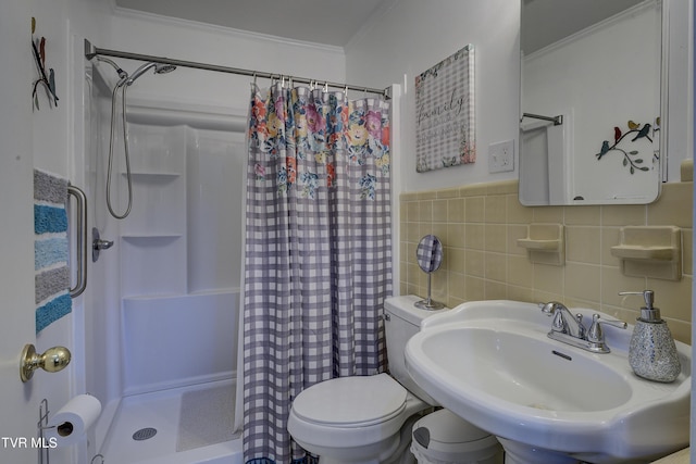 full bath featuring a stall shower, toilet, ornamental molding, a sink, and tile walls