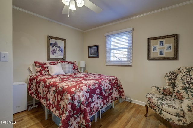 bedroom featuring ornamental molding, light wood-type flooring, ceiling fan, and baseboards