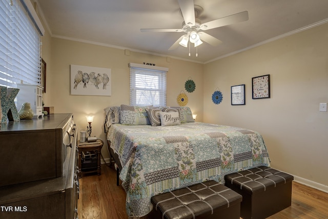 bedroom with a ceiling fan, dark wood-style flooring, crown molding, and baseboards