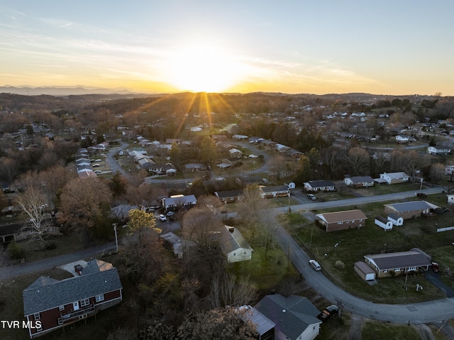 aerial view at dusk featuring a residential view