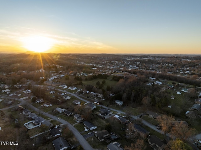 aerial view at dusk featuring a residential view