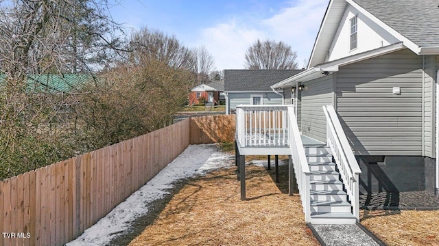 view of yard with a deck, stairway, and a fenced backyard